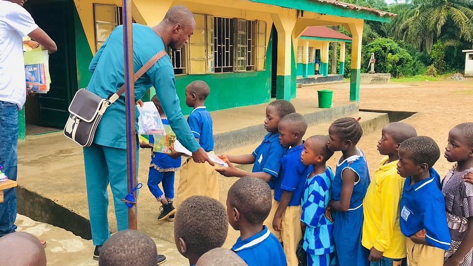Hand overing the education materials to pupils